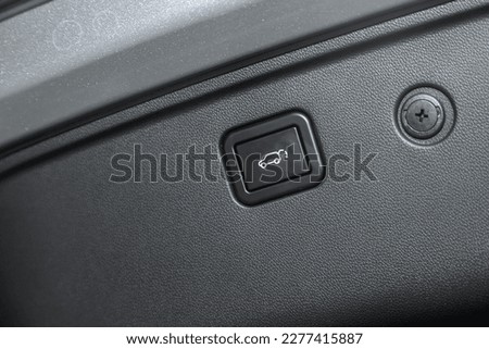 Сlose-up of the car  black interior: trunk release button