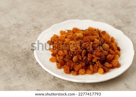 Organic Dried Golden Raisins in White Plate