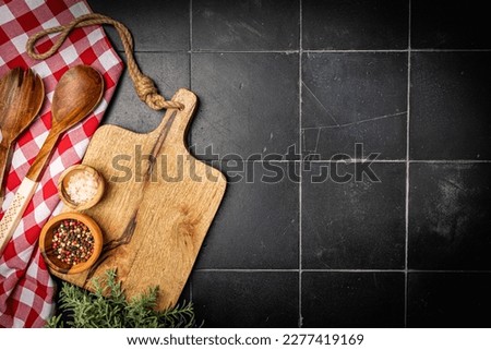 Old wooden kitchen utensils or cooking tools on black background, top view, flat lay. Kitchenware collection with copy space. Cooking background. Royalty-Free Stock Photo #2277419169