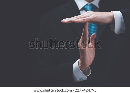 Businessman showing hand sign ,pause or request a break ,time out gesture sign ,time for a break ,Gestures asking for time to consult or clarify Royalty-Free Stock Photo #2277424795