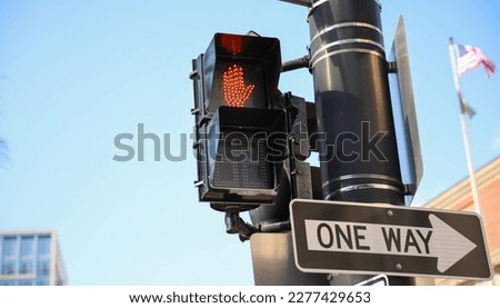 street traffic light during rush hour at crosswalk red and yellow at intersection for pedestrian safety depicting a control  warning and caution in urban street with signaling danger