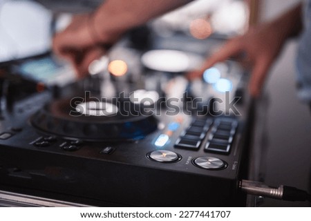 DJ Spinning. mixing and scratching in a night club. DJ playing music at mixer. Closeup. Party.