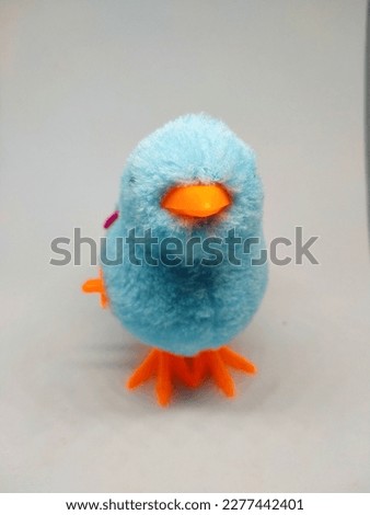 a children's toy shaped like a bird in light blue