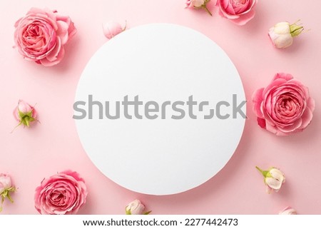 Mother's Day concept. Top view photo of white circle and natural flowers pink peony rose buds on isolated light pink background with empty space