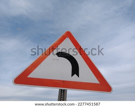 dangerous bend to the left traffic sign