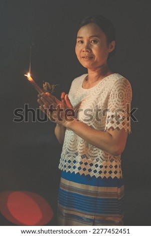 Asian people praying on black background