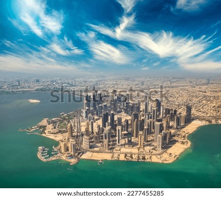 Aerial view of Doha skyline from airplane. Modern skyscrapers at sunset, Qatar. Royalty-Free Stock Photo #2277455285