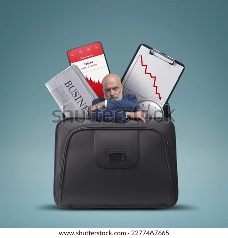 Stressed sad businessman and financial graphs showing loss in a briefcase, financial failure concept Royalty-Free Stock Photo #2277467665