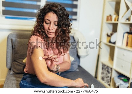 Woman at home using products for hormone replacement therapy. Royalty-Free Stock Photo #2277468495