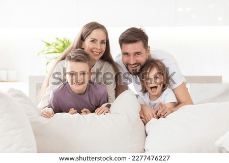 A happy family with kids on the couch in living room