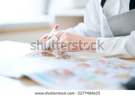 Woman looking at grocery advertisement