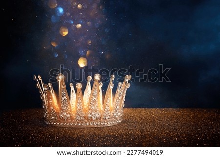 low key image of beautiful queen or king crown over glitter table. fantasy medieval period Royalty-Free Stock Photo #2277494019