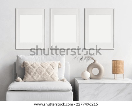 Three blank picture frame mockups on a wall. Vertical orientation. Artwork templates in interior design Royalty-Free Stock Photo #2277496215
