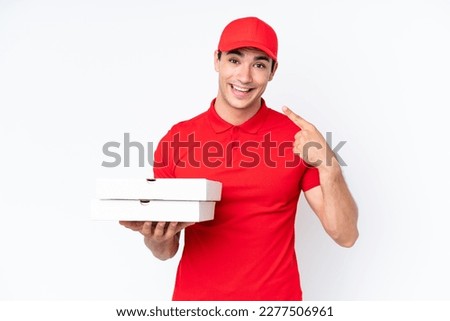 Pizza delivery caucasian man with work uniform picking up pizza boxes isolated on white background giving a thumbs up gesture