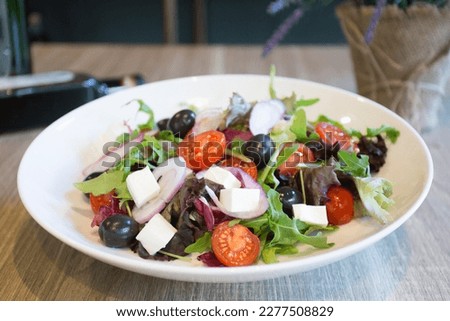 Delicious and healthy salad with a variety of cheeses and tomatoes.