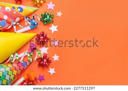 Flat lay composition with accessories for birthday party on orange background. Space for text