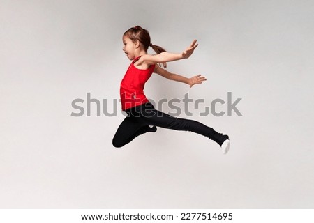 Young girl gymnast on white background with copy space.