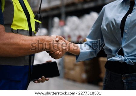 Warehouse manager handshake together with business partner, supplier, investment trust honesty team to supply product, delivery shipment to factory for logistic distribution. Inventory, store, storage Royalty-Free Stock Photo #2277518381