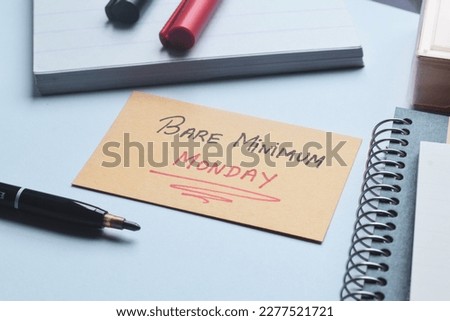 Bare Minimum Monday handwritten text on card on office desk. New work trend concept. Royalty-Free Stock Photo #2277521721