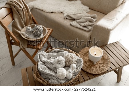 Threads for knitting in the interior of the room, a cozy composition with yarn.