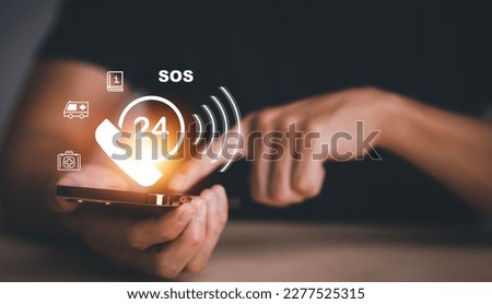 Hand touch button Emergency app in home, call phone, Chat message icon, Emergency application from smartphone for elderly, technology concept.Old hand touch mobile phone and call for help. Royalty-Free Stock Photo #2277525315