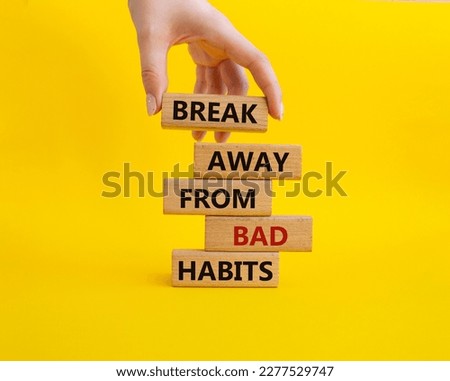 Break away from bad habits symbol. Wooden blocks with words Break away from bad habits. Beautiful yellow background. Businessman hand. Business and Break away from bad habits concept. Copy space.