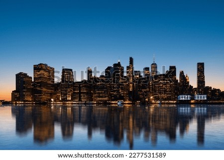 Magnificent night New York city and its reflection in the Hudson river. New York, the United States of America. Concept of sightseeing and tourism