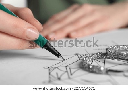 Jeweler drawing sketch of diamond on paper, closeup