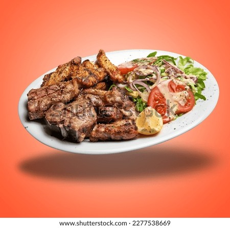 Floating White plate with Mixed meat grilled and salad  on orange gradient background Royalty-Free Stock Photo #2277538669