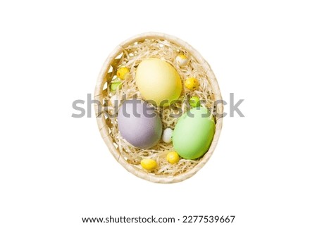 Basket of colorful Easter eggs isolated on white background. Easter basket filled with colored eggs top view holiday concept .