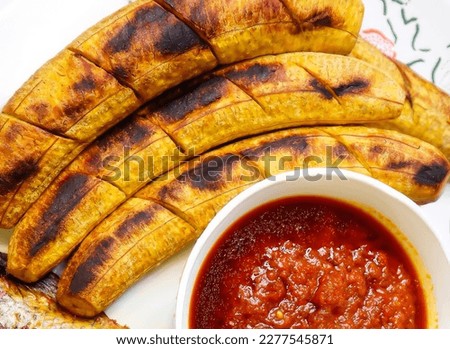 Bole is a roasted plantain dish in Nigeria. It is native to the Yoruba people of Nigeria. It is eaten with groundnuts Royalty-Free Stock Photo #2277545871
