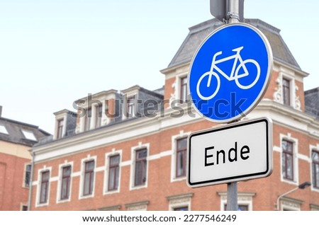 Bike lane ends sign in city, closeup