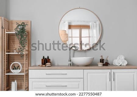 Interior of light bathroom with counters, sink and mirror Royalty-Free Stock Photo #2277550487