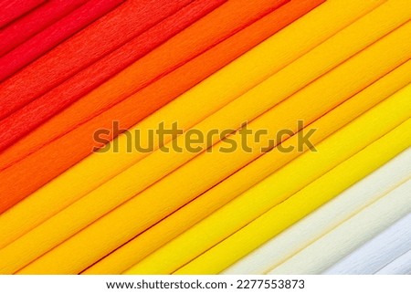 Warm colors crepe paper arranged diagonally to make a background