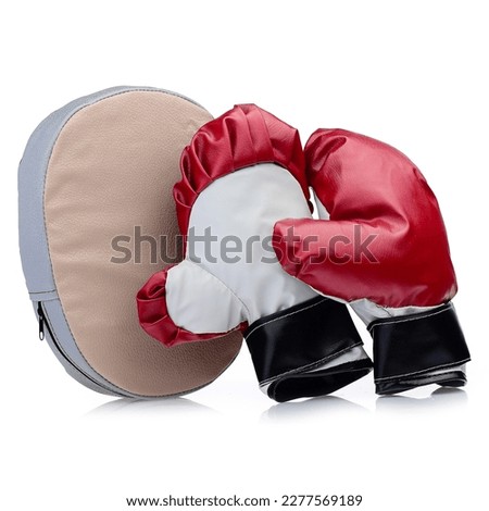 A pair of boxing leather gloves for a child isolated on a white background. Children's red boxing gloves and a pear.