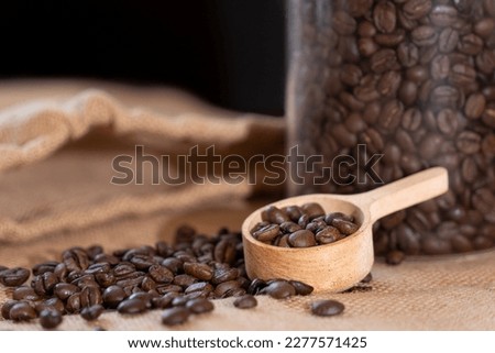 Many coffee beans and coffee spoon