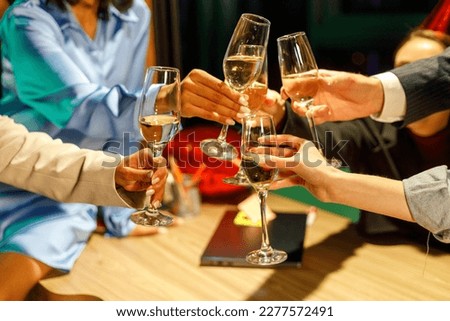 Cropped view portrait of attractive cheerful people employers gathering celebrating festive clinking glasses	
