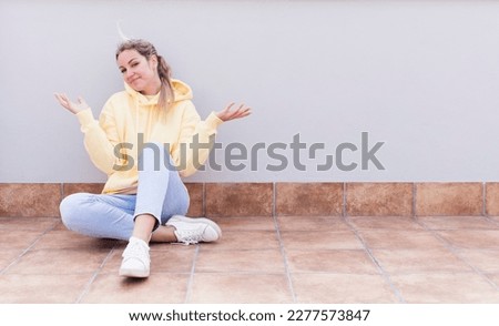 pretty caucasian sitting  woman feeling puzzled and confused, doubting, weighting or choosing different options