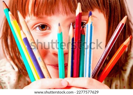 Young great artist. Close up portrait of beautiful child girl with pencils learning to paint. 