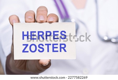 White sticker with text HERPES ZOSTER in doctor's hands with a stethoscope