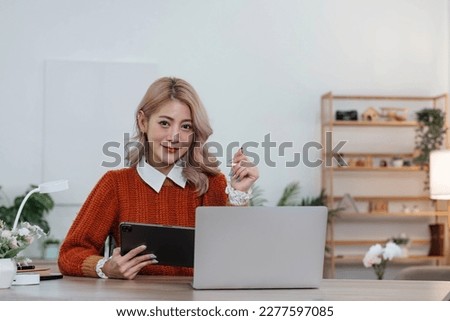 Young asian woman using tablet with smiling face, positive emotion, at home, casual home life concept