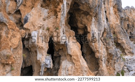 Close up of the rocky cliff of the mountain. Detailed view of eroded rock formation. Sandstone mountain rock texture.