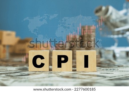 CPI, consumer price index symbol.Wooden block with words CPI with shopping basket and stack coin background, consumer price index on dollar bills. Business and CPI, consumer price index concept. Royalty-Free Stock Photo #2277600185