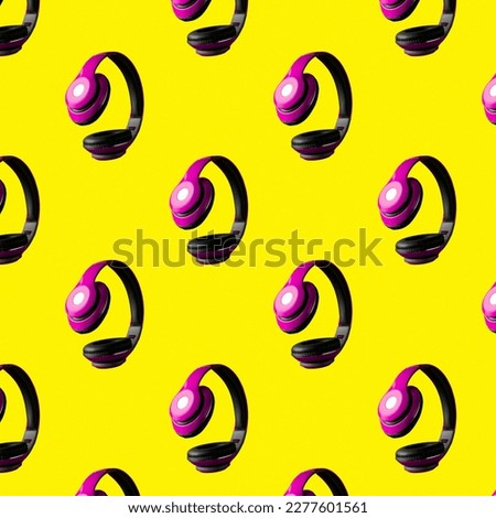 A lot of purple headphones on a bright yellow background. The concept of modern music. Top view redevelopment. Fashion wallpaper for headset. Flatley. Tech hipster accessory