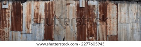 Background made of rusted iron sheet metal and corrugated iron which are fastened together. Widescreen image Royalty-Free Stock Photo #2277605945