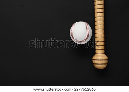 Wooden baseball bat and ball on black background, flat lay. Space for text