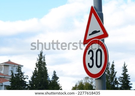 Post with road signs Maximum Speed 30 and Speed Bump outdoors on sunny day, space for text