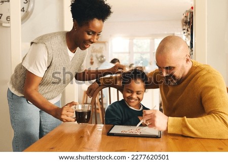 Parents and son with Down syndrome drawing on digital tablet Royalty-Free Stock Photo #2277620501