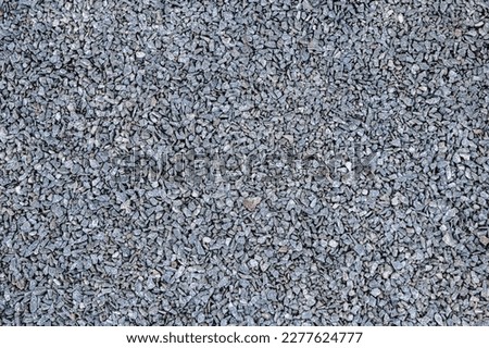 Small stones wall used for background texture.Small Rock Textured background. Seamless texture of gravel. crushed granite texture. Royalty-Free Stock Photo #2277624777