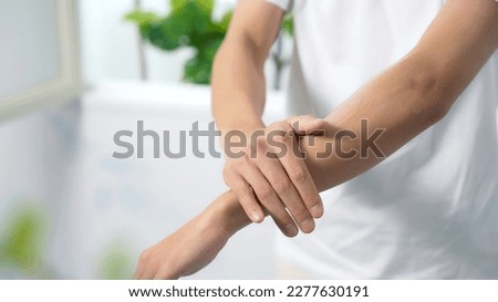 Man applying cream to arm. Moisturizing cream. Sunscreen. Royalty-Free Stock Photo #2277630191